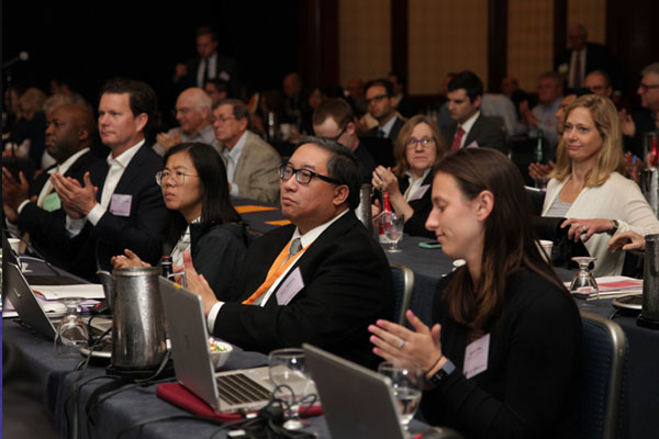 KF Law Tax Forum attendees speaking on the floor